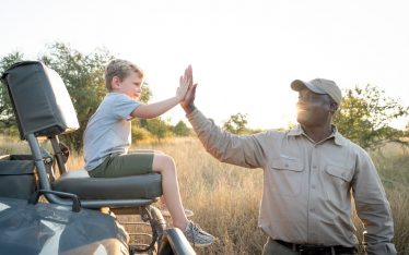 A guide and child on safari in the Kruger National Park