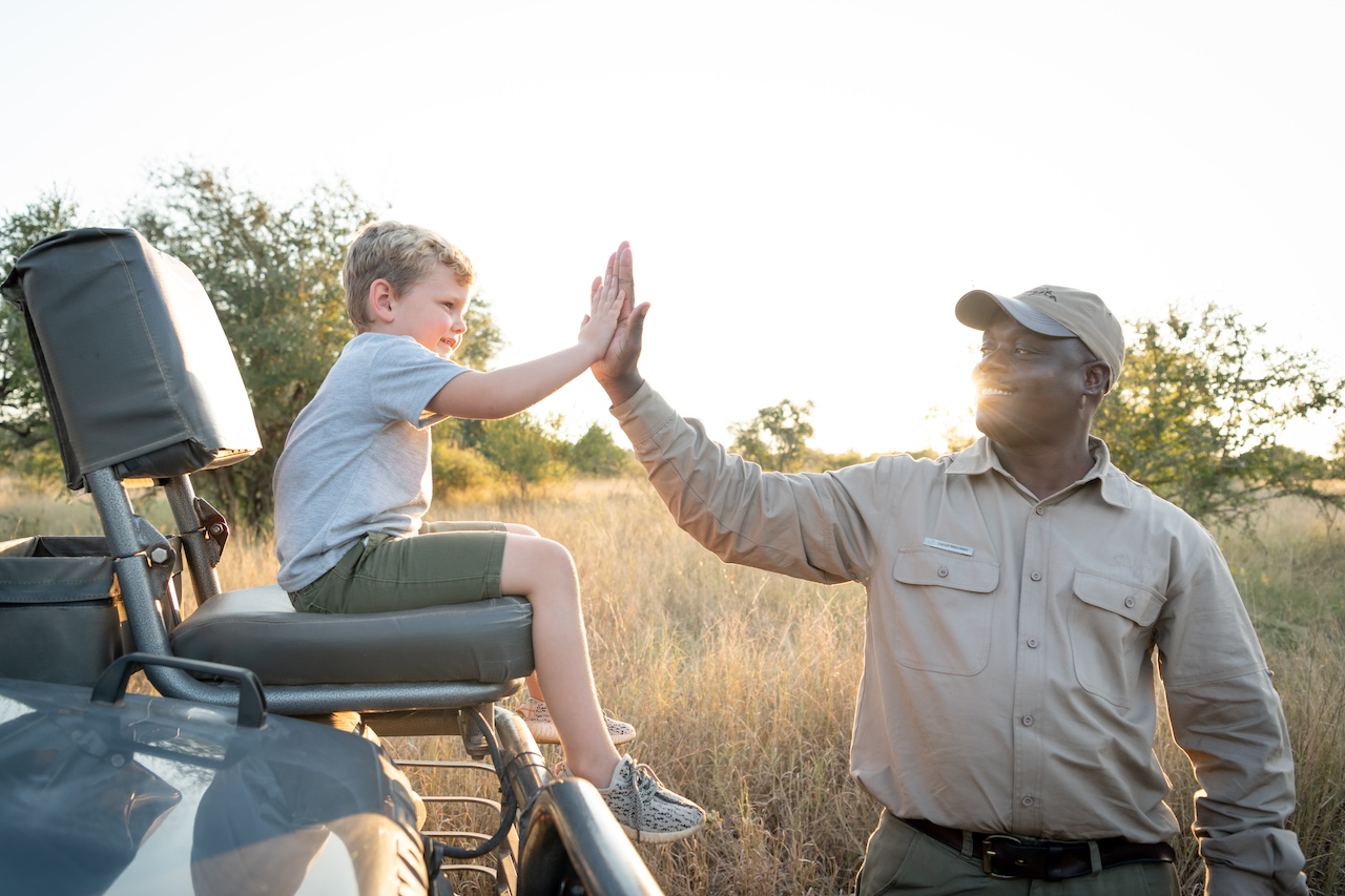 A guide and child on safari in the Kruger National Park